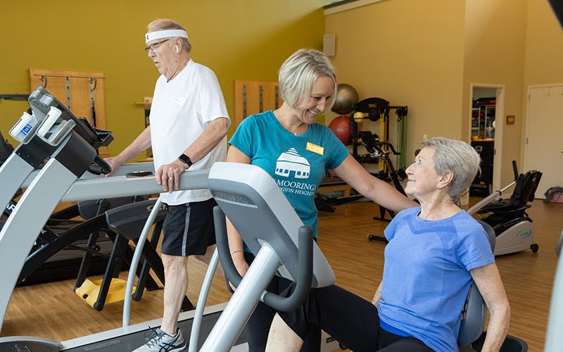 Trainer working with a resident in the Fitness Center at The Moorings of Arlington Heights