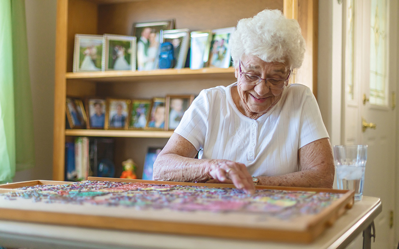 Active Senior Woman Working on Jigsaw Puzzle