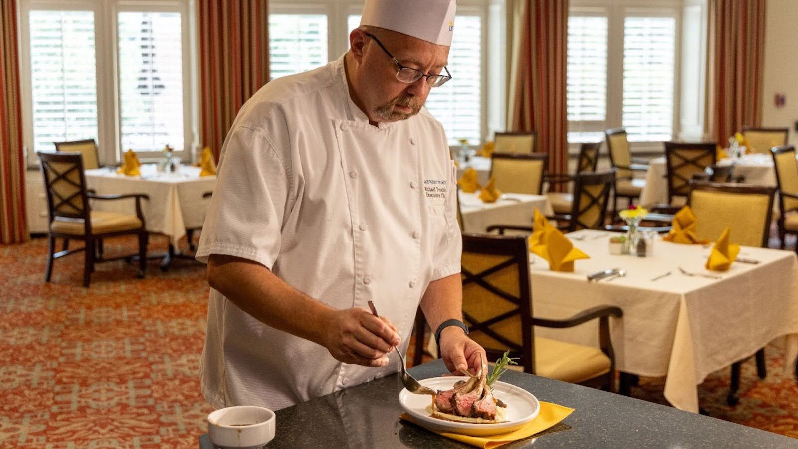 A chef at Lake Forest Place preparing a delicious meal for the residents