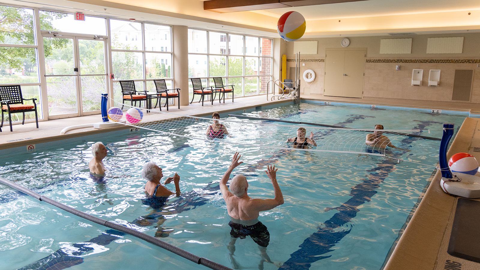 Residents of The Moorings of Arlington Heights playing pool volleyball