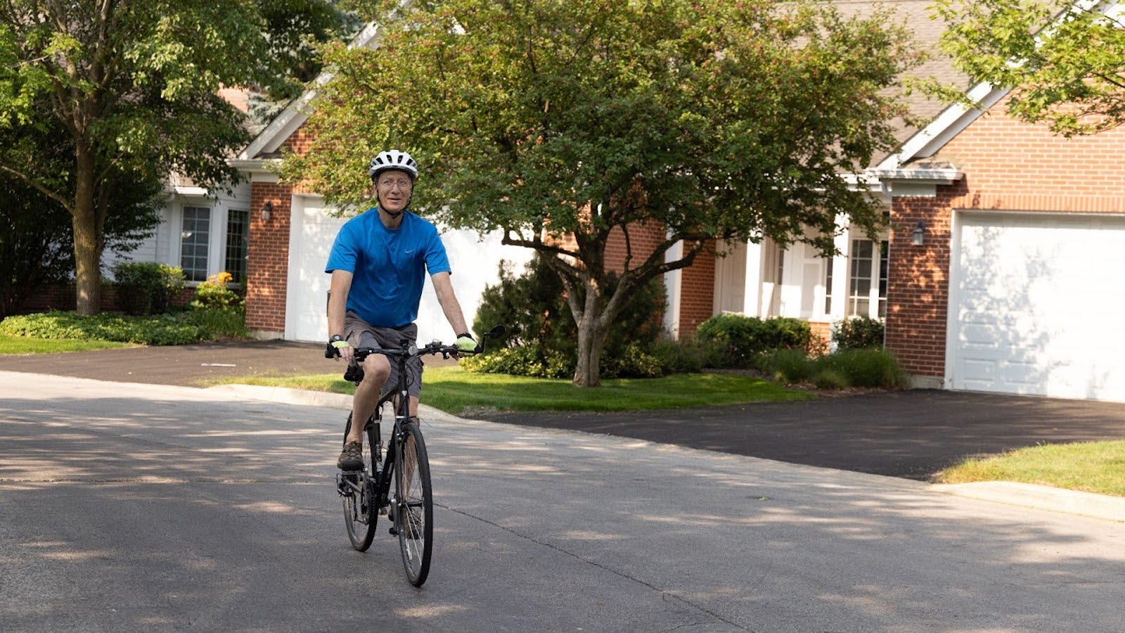 Resident of The Moorings of Arlington Heights wearing a protective helmet while riding his bike