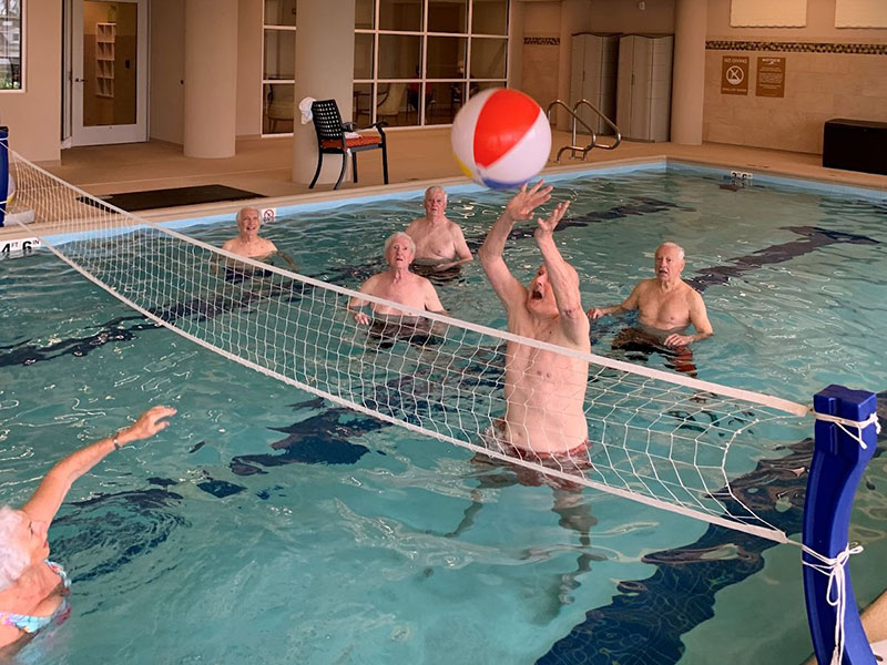 Resisents of The Moorings of Arlington Heights participating in a pool volleyball event