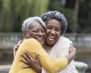 two senior women hugging