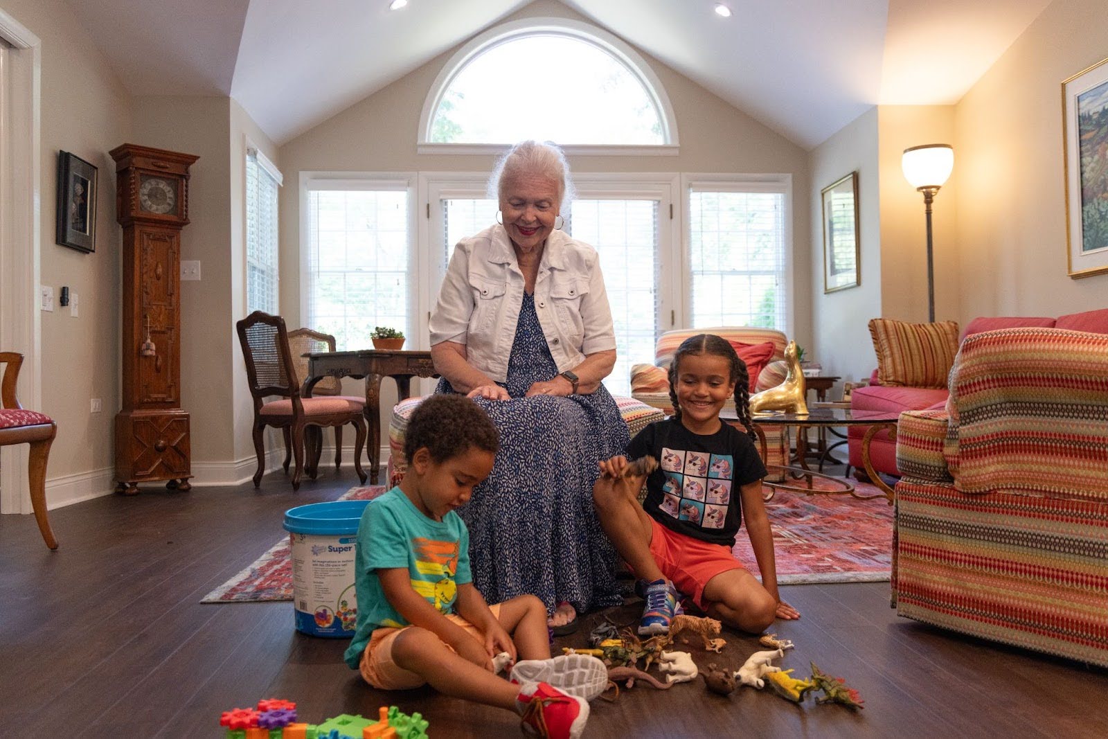 Resident of Westminster Place playing with her grandchildren in her apartment home