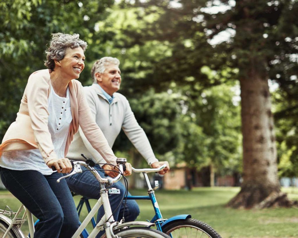 a senior man and woman riding bikes