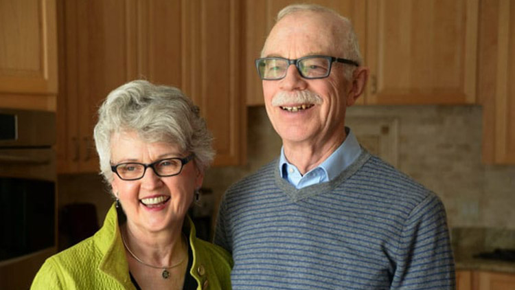 a senior couple smiling and posing for a photo